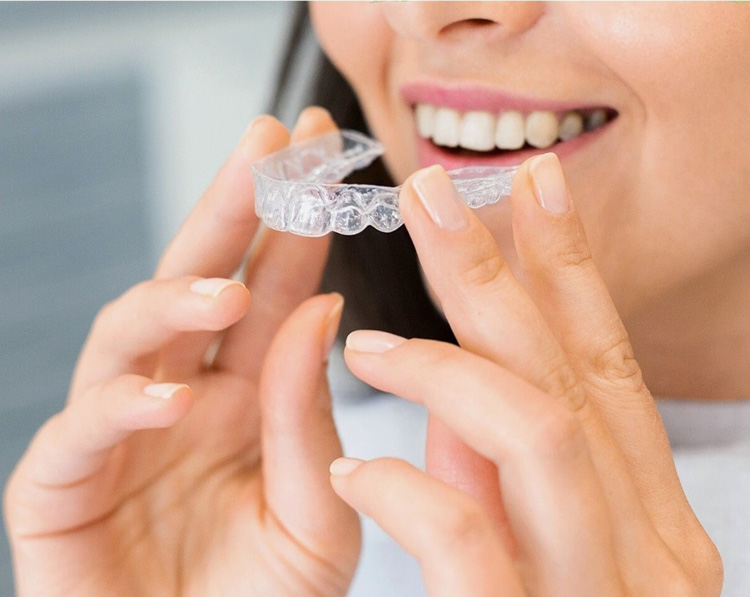 Girl with Invisalign clear aligners in Oklahoma City