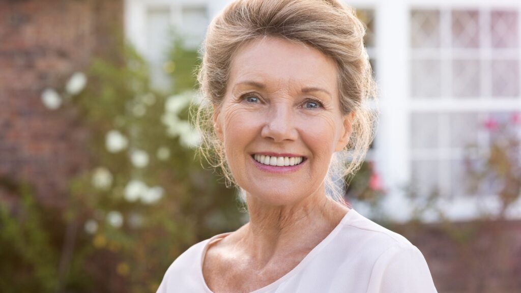 A mature woman with implant-supported dentures.